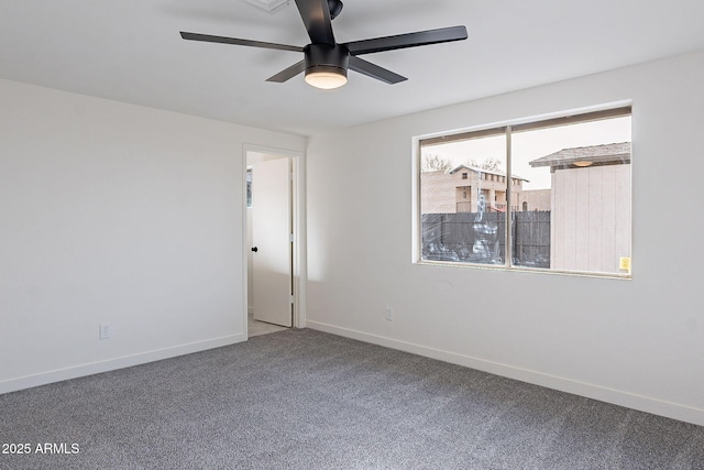 unfurnished room with ceiling fan, carpet flooring, and baseboards