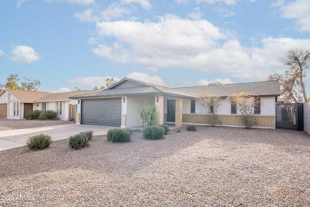 ranch-style home featuring concrete driveway, brick siding, an attached garage, and fence