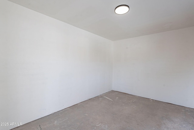 unfurnished room featuring unfinished concrete floors