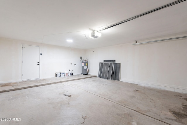 garage with baseboards, a garage door opener, and electric water heater