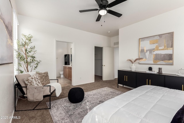 bedroom with a walk in closet, light colored carpet, visible vents, connected bathroom, and baseboards