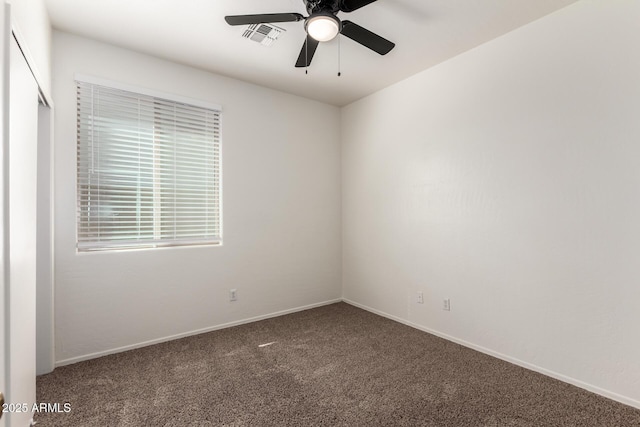 empty room featuring carpet floors, visible vents, baseboards, and a ceiling fan