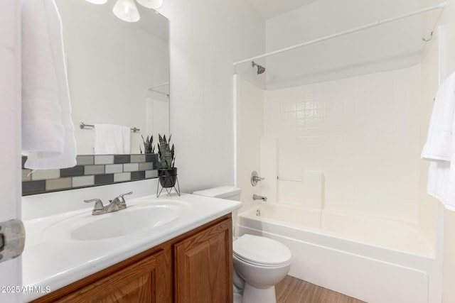 full bath featuring vanity, shower / tub combination, and toilet