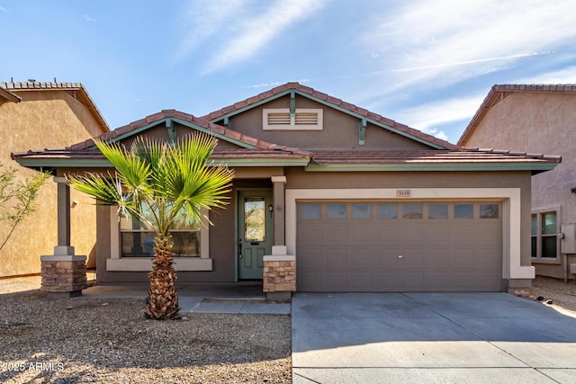 view of front facade with a garage, driveway, and stucco siding