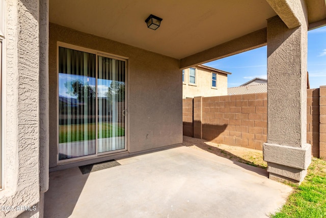 view of patio featuring fence