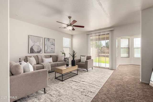 carpeted living room featuring ceiling fan