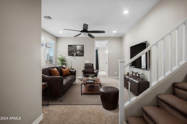 carpeted living room with ceiling fan