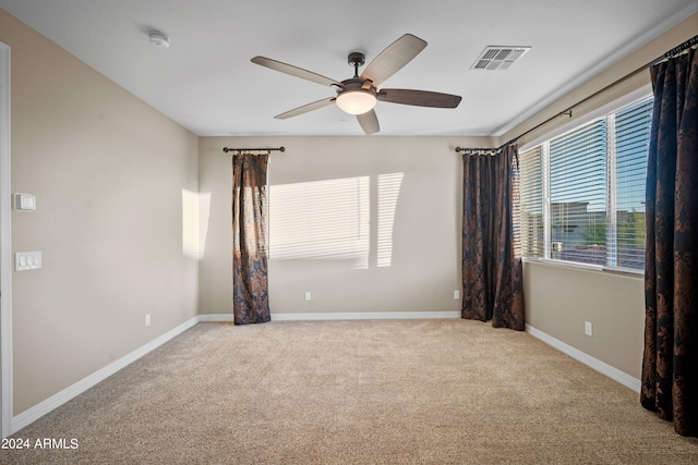 unfurnished room featuring light carpet and ceiling fan