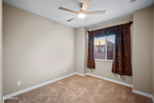 carpeted empty room with ceiling fan