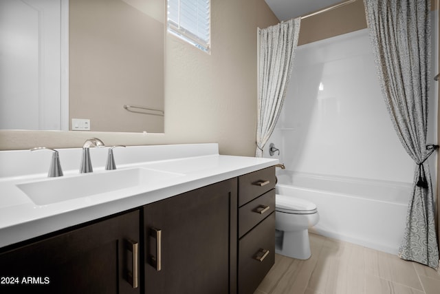 full bathroom with shower / bath combo with shower curtain, vanity, and toilet