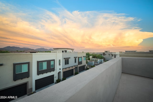 balcony at dusk featuring a mountain view