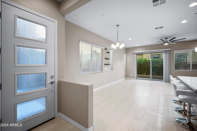 foyer entrance featuring ceiling fan