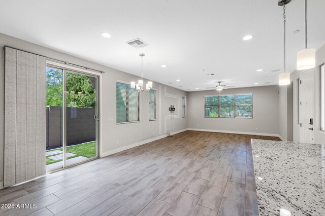 8313 E Impala Ave, Mesa, AZ 85209 - unfurnished living room with plenty of natural light, a chandelier, wood finished floors, recessed lighting, and baseboards