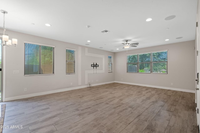 8313 E Impala Ave, Mesa, AZ 85209 - unfurnished living room featuring light wood-type flooring, a chandelier, ceiling fan, recessed lighting, and baseboards