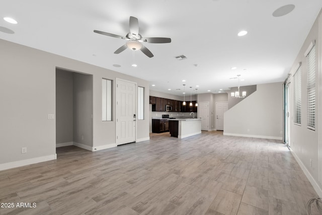 8313 E Impala Ave, Mesa, AZ 85209 - unfurnished living room featuring ceiling fan, recessed lighting, a chandelier, baseboards, and a sink