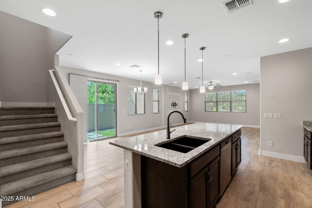 8313 E Impala Ave, Mesa, AZ 85209 - kitchen featuring a sink, open floor plan, dark brown cabinetry, healthy amount of natural light, and recessed lighting
