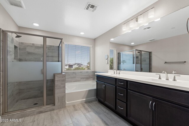 8313 E Impala Ave, Mesa, AZ 85209 - full bathroom with a bath, a shower stall, double vanity, and recessed lighting