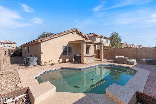 rear view of house featuring an outdoor living space, a fenced in pool, cooling unit, and a patio area