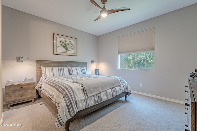 bedroom featuring light carpet and ceiling fan