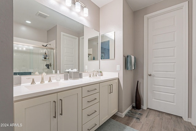 bathroom featuring vanity, a shower with shower door, and hardwood / wood-style floors