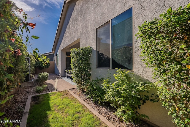 view of side of property featuring a patio area