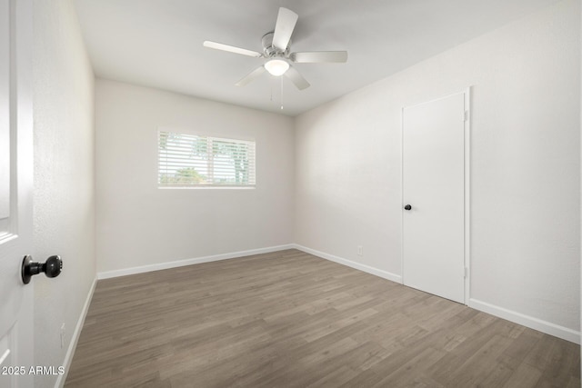 1628 E Sunland Ave, Phoenix, AZ 85040 - empty room with wood finished floors, ceiling fan, and baseboards