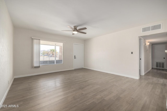 1628 E Sunland Ave, Phoenix, AZ 85040 - empty room with a ceiling fan, baseboards, and wood finished floors