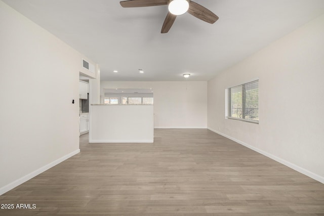 1628 E Sunland Ave, Phoenix, AZ 85040 - unfurnished living room with baseboards, light wood-type flooring, ceiling fan, and recessed lighting