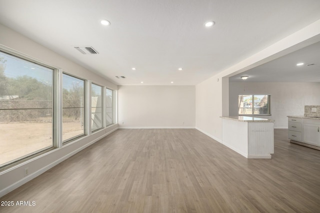 1628 E Sunland Ave, Phoenix, AZ 85040 - unfurnished living room with light wood-style floors, recessed lighting, and baseboards