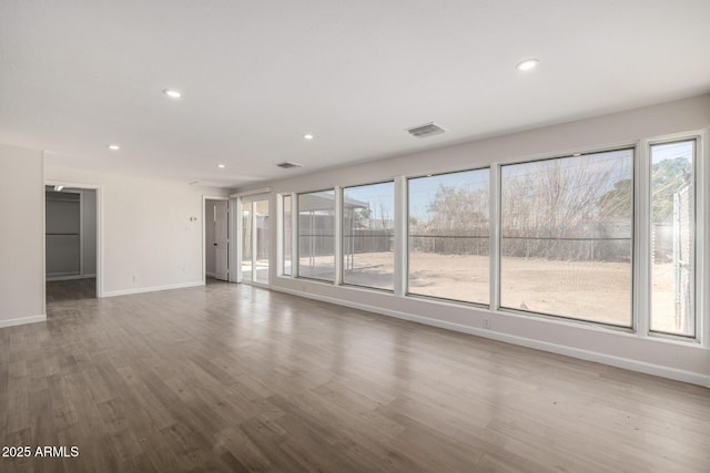 1628 E Sunland Ave, Phoenix, AZ 85040 - empty room featuring baseboards, recessed lighting, wood finished floors, and plenty of natural light