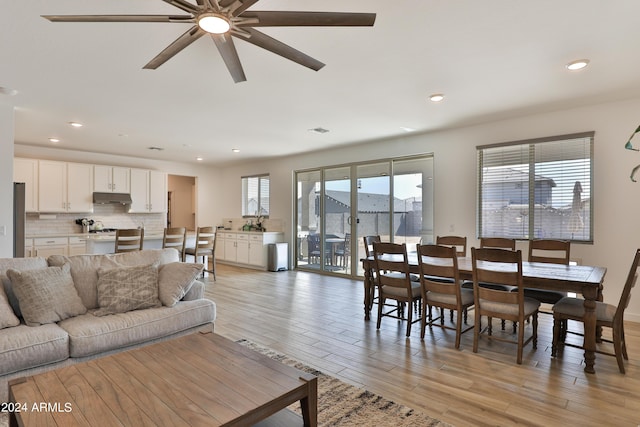 living room with recessed lighting, a ceiling fan, and light wood-style floors