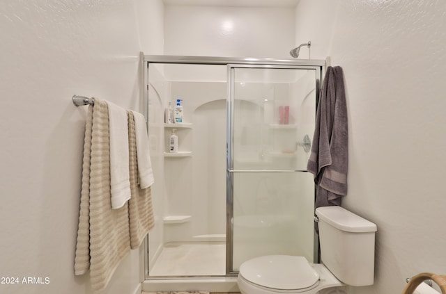 full bath with toilet and a stall shower