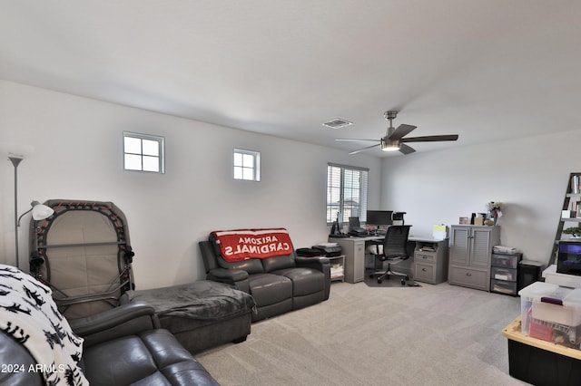 office space with ceiling fan, visible vents, and light colored carpet