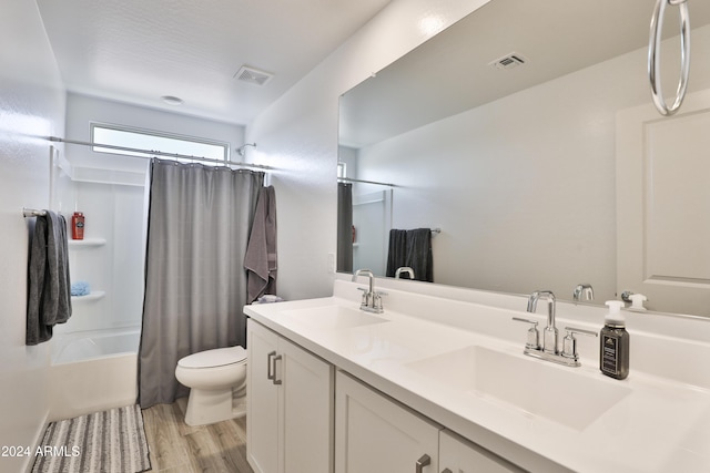 bathroom with toilet, shower / bath combination with curtain, a sink, and visible vents