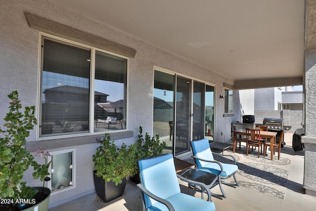 view of patio with outdoor dining area, area for grilling, and fence