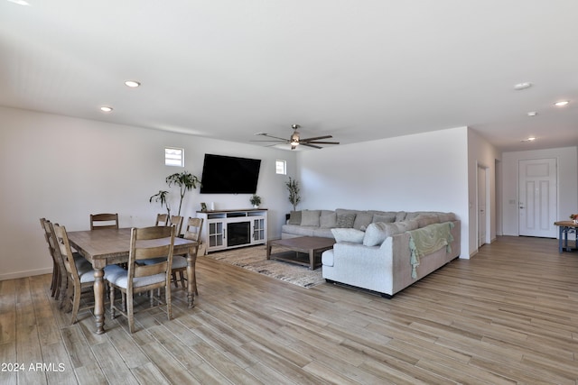 living room featuring ceiling fan, light wood finished floors, and recessed lighting