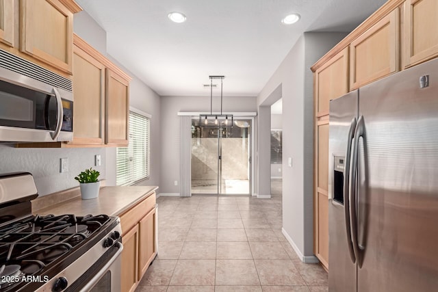 kitchen featuring light tile patterned floors, recessed lighting, stainless steel appliances, baseboards, and light brown cabinetry