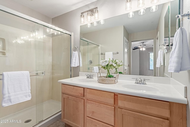 bathroom featuring double vanity, a sink, a ceiling fan, and a shower stall