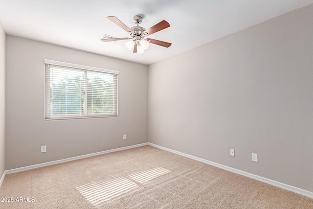 unfurnished room featuring light colored carpet, ceiling fan, and baseboards