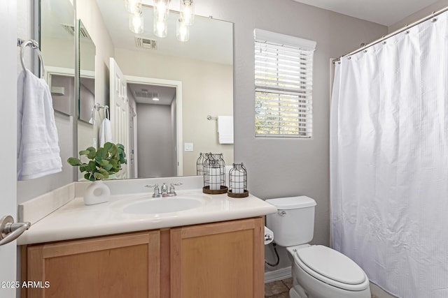 bathroom featuring a shower with curtain, visible vents, vanity, and toilet