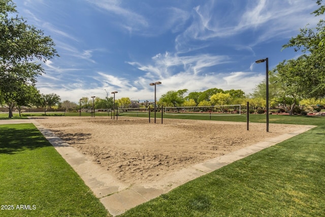 view of property's community with volleyball court and a lawn