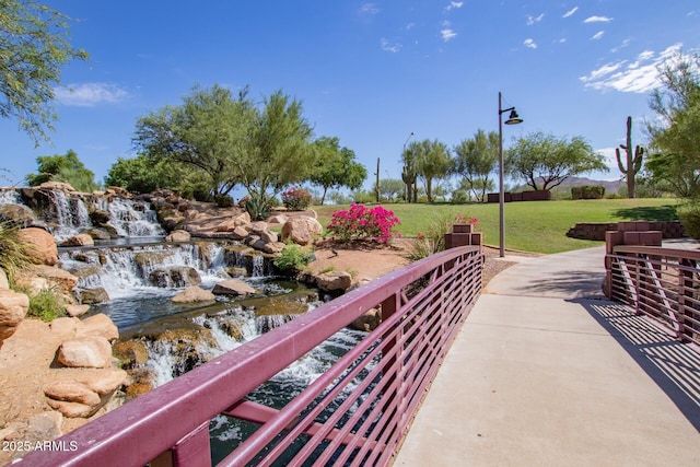 view of property's community with a lawn and a patio area