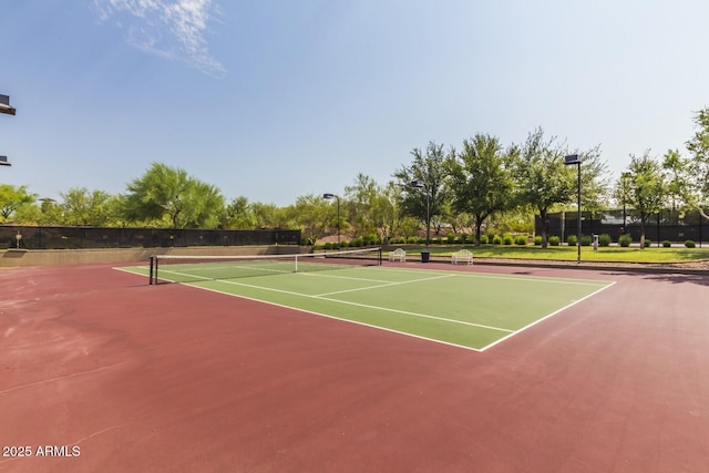 view of sport court featuring fence