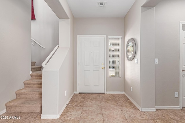 entryway featuring visible vents, stairway, and baseboards