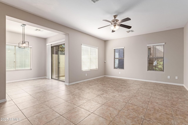 unfurnished room featuring ceiling fan, light tile patterned flooring, visible vents, and baseboards