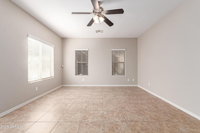 empty room featuring visible vents, baseboards, a ceiling fan, and light tile patterned flooring