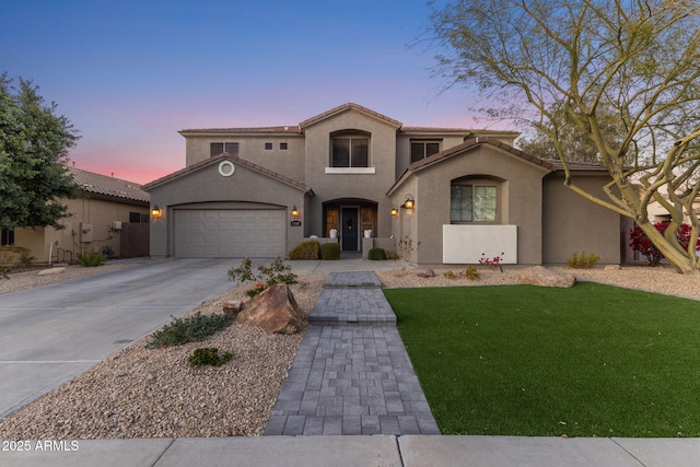 mediterranean / spanish-style home featuring a garage and a lawn