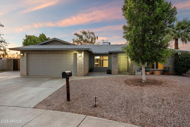 2726 W Meseto Cir, Mesa, AZ 85202 - view of front facade with a garage, driveway, brick siding, and roof with shingles