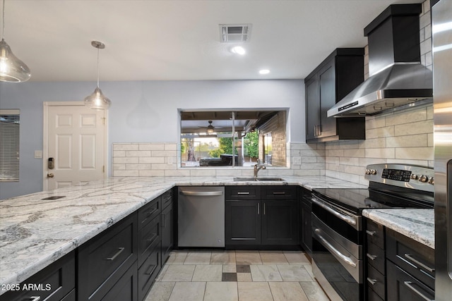 2726 W Meseto Cir, Mesa, AZ 85202 - kitchen featuring stainless steel appliances, wall chimney range hood, decorative backsplash, light stone countertops, and dark cabinets