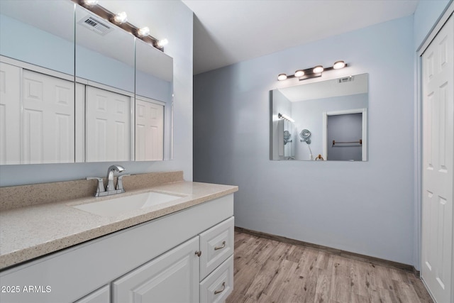 2726 W Meseto Cir, Mesa, AZ 85202 - bathroom featuring a closet, vanity, and wood finished floors